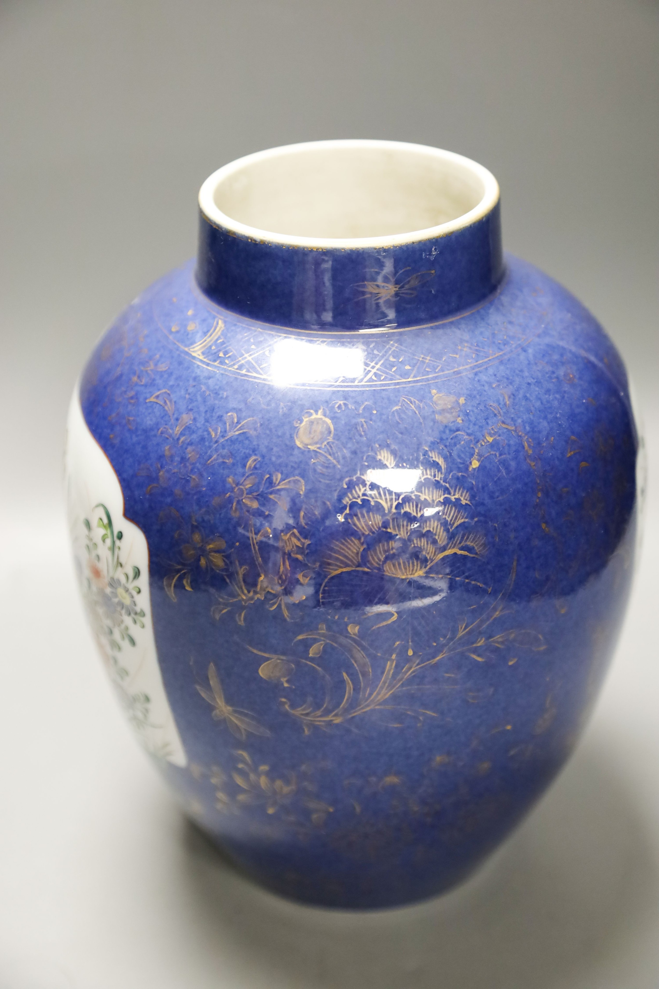 A Chinese Kangxi blue and white hundred antiques jar, 21cm, cracked, with hardwood stand and a Samson powder blue jar, 26cm, wear